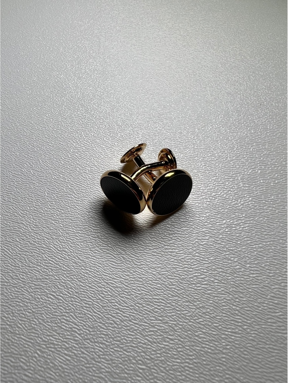 Gold tone black oval cufflinks